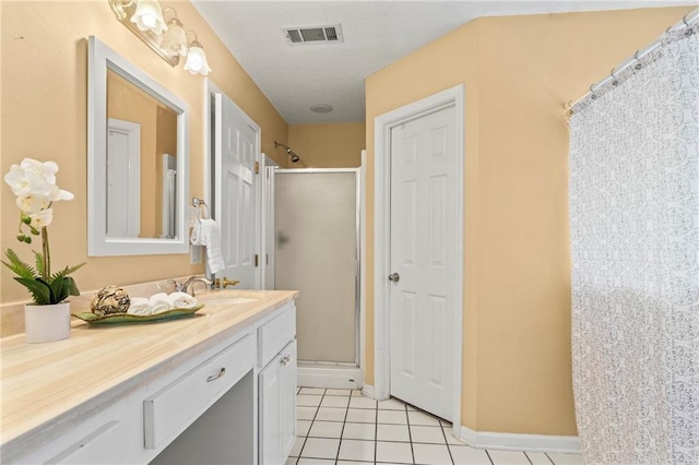 bathroom featuring tile patterned floors, vanity, and a shower