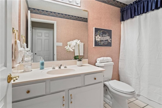 bathroom featuring tile patterned flooring, vanity, and toilet