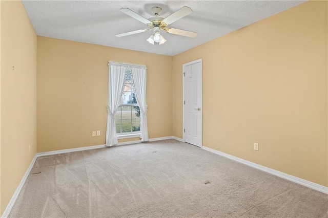 carpeted empty room with a textured ceiling and ceiling fan