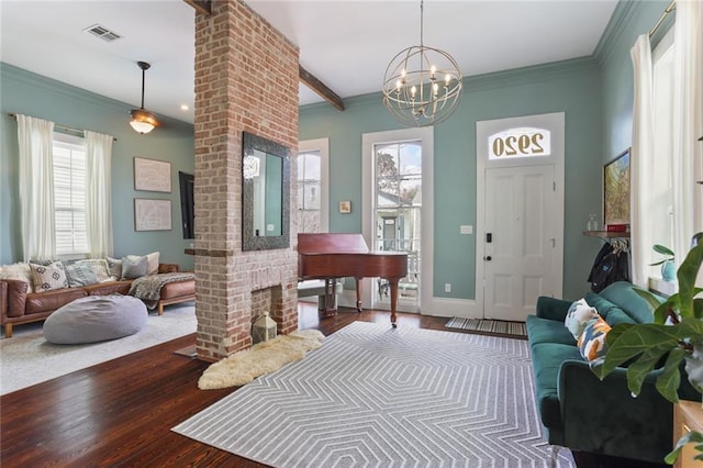 foyer with ornamental molding, dark wood-type flooring, and a wealth of natural light