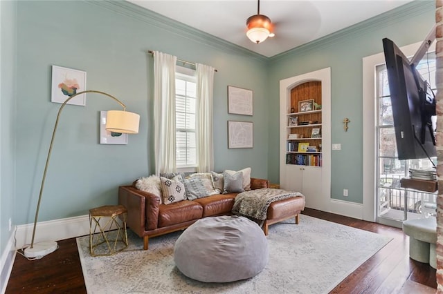 sitting room featuring ornamental molding, dark hardwood / wood-style floors, and built in features