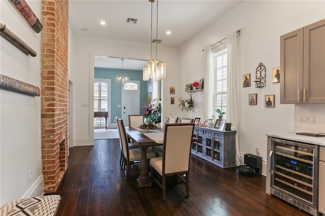 dining space featuring wine cooler, dark hardwood / wood-style flooring, and a wealth of natural light