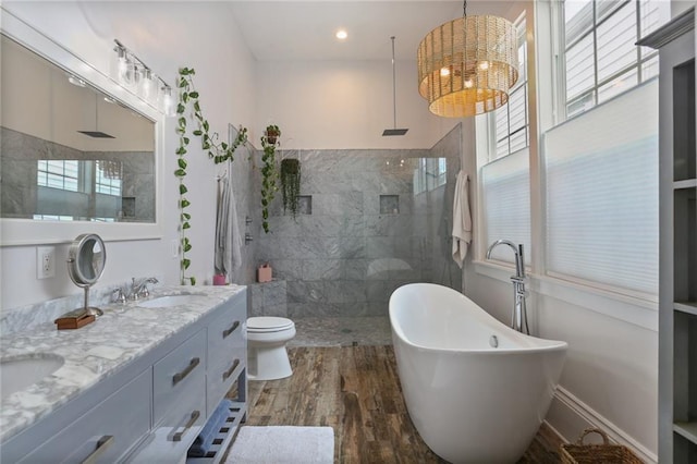 full bathroom featuring toilet, vanity, shower with separate bathtub, and hardwood / wood-style floors