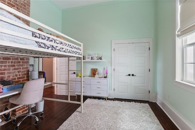 bedroom with a towering ceiling and dark hardwood / wood-style flooring