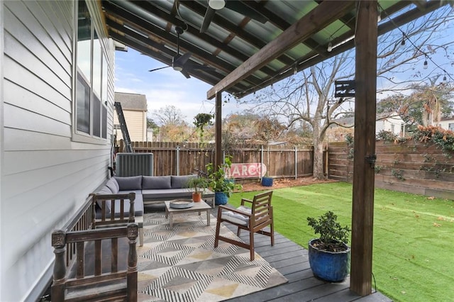 wooden deck featuring an outdoor hangout area and a lawn