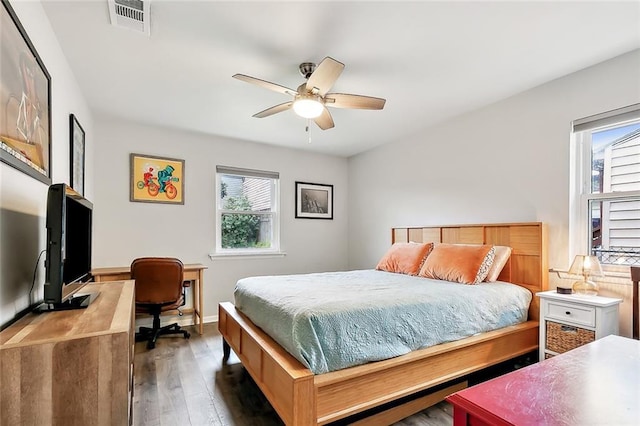 bedroom with ceiling fan and dark hardwood / wood-style flooring