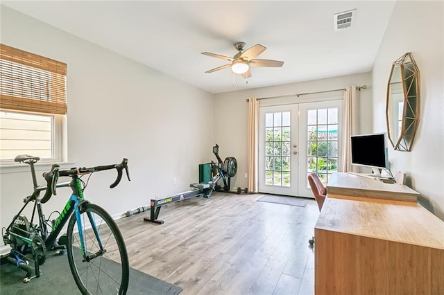 exercise room with french doors, ceiling fan, and light wood-type flooring