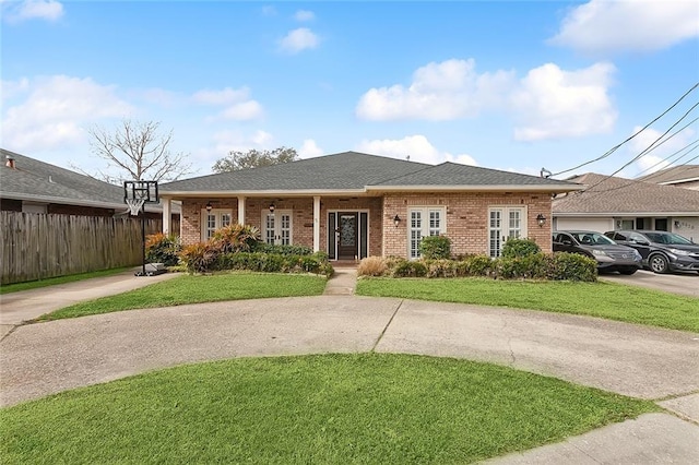 view of front of property with covered porch and a front yard