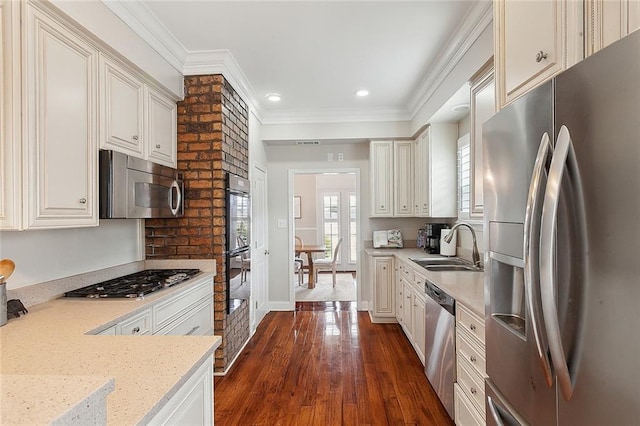 kitchen with sink, ornamental molding, dark hardwood / wood-style flooring, stainless steel appliances, and light stone countertops