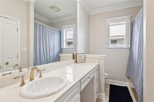 bathroom with vanity, tile patterned flooring, crown molding, and toilet