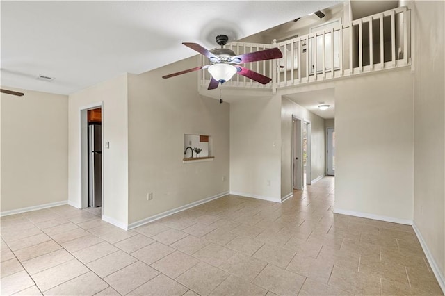 tiled empty room with ceiling fan