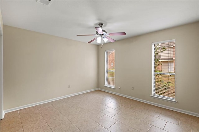 spare room featuring light tile patterned floors and ceiling fan