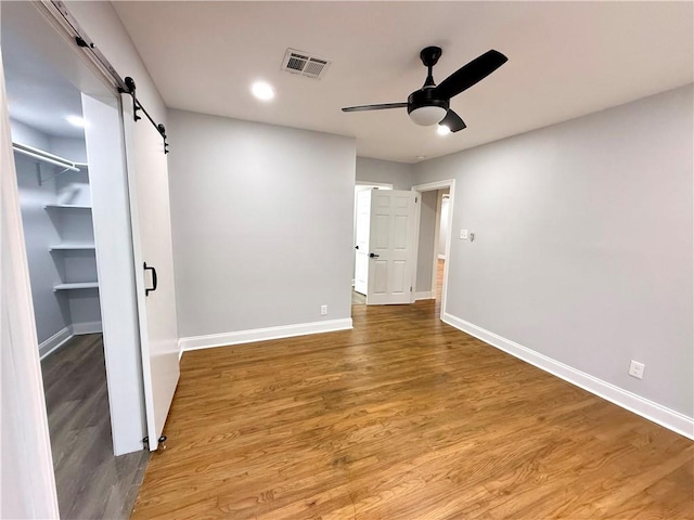 532 Gardere Ave, Harvey, LA 70058 - unfurnished bedroom with a barn door, baseboards, and visible vents