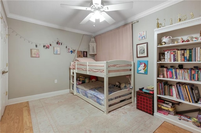 bedroom with ornamental molding, ceiling fan, and light hardwood / wood-style floors