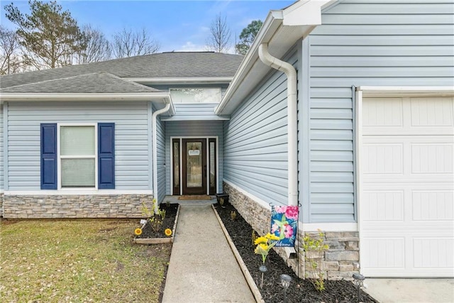 doorway to property with a garage