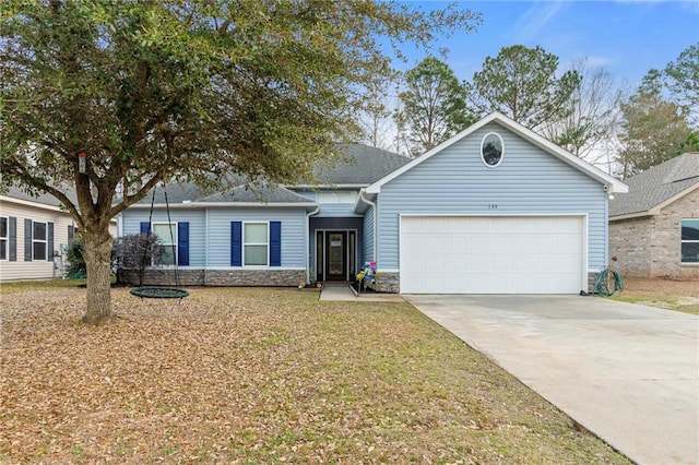 ranch-style house featuring a garage and a front yard