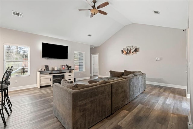 living room with hardwood / wood-style flooring, vaulted ceiling, and ceiling fan