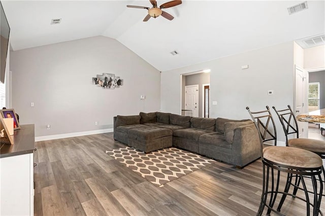 living room with ceiling fan, lofted ceiling, and wood-type flooring