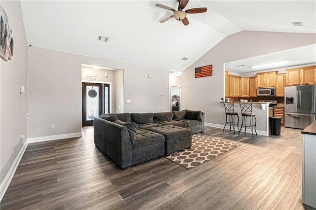 living room featuring hardwood / wood-style flooring, high vaulted ceiling, and ceiling fan