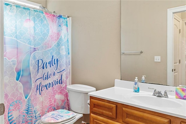 bathroom with vanity, toilet, and a shower with shower curtain