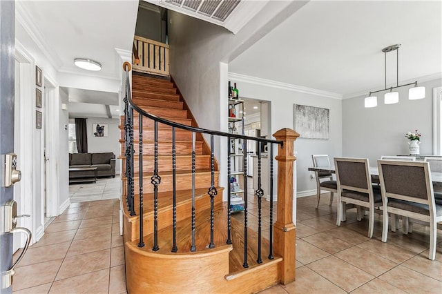 stairs with tile patterned flooring and crown molding