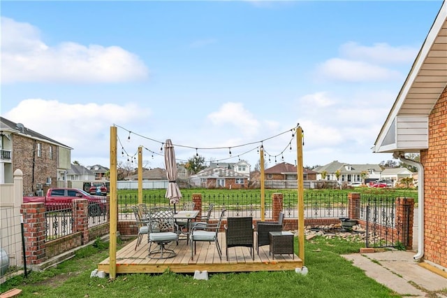 view of playground with a wooden deck and a yard