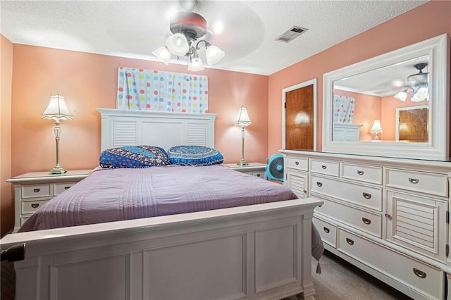 carpeted bedroom featuring a textured ceiling