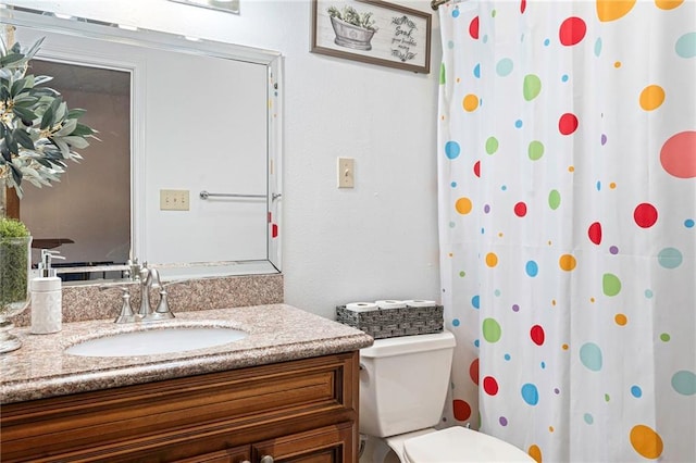 bathroom featuring vanity and toilet