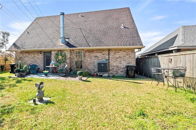 rear view of property featuring central AC, a lawn, and a patio