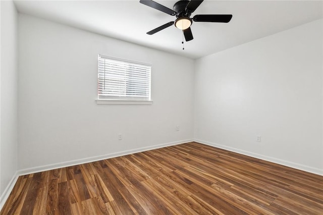 spare room featuring baseboards, ceiling fan, and wood finished floors