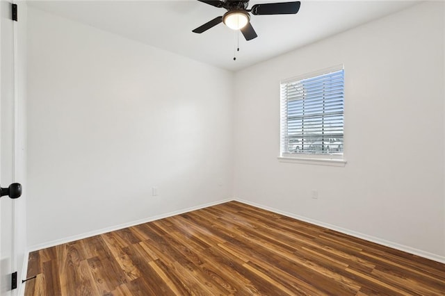 spare room with a ceiling fan, baseboards, and wood finished floors