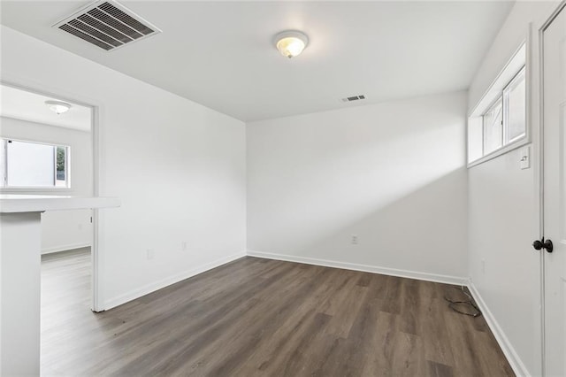 spare room with dark hardwood / wood-style floors