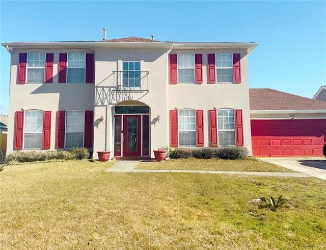 view of front of property featuring a garage and a front lawn