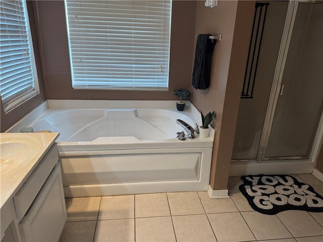 bathroom featuring tile patterned floors, vanity, and independent shower and bath