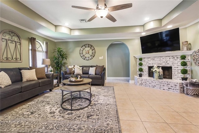 6900 Royal St, Arabi, LA 70032 - tiled living area with arched walkways, ceiling fan, a tray ceiling, baseboards, and recessed lighting