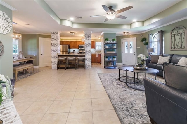 6900 Royal St, Arabi, LA 70032 - living room featuring a raised ceiling, light tile patterned floors, plenty of natural light, ornamental molding, and recessed lighting