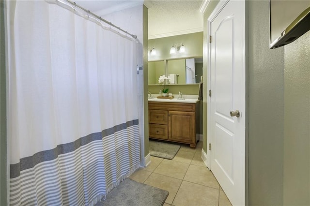 6900 Royal St, Arabi, LA 70032 - bathroom with vanity, tile patterned flooring, ornamental molding, a shower with shower curtain, and a textured ceiling