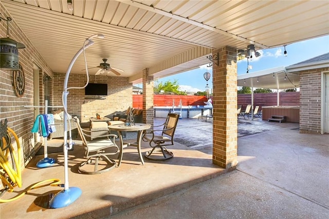 6900 Royal St, Arabi, LA 70032 - fenced backyard featuring a hot tub, a ceiling fan, a patio, a swimming pool, and outdoor dining space