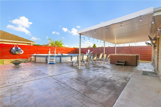 6900 Royal St, Arabi, LA 70032 - fenced backyard featuring a hot tub, a patio area, and a pool