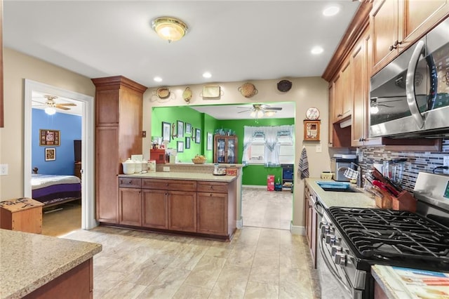 kitchen with stainless steel appliances, sink, and backsplash