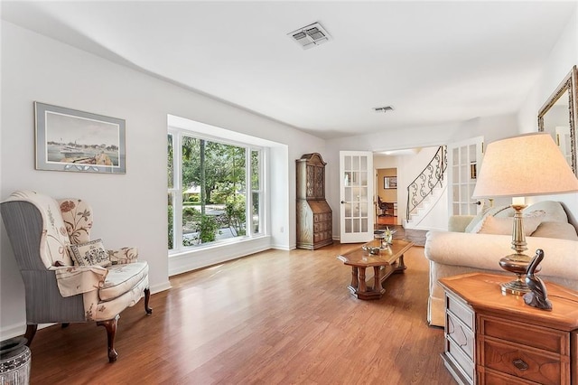 living room with hardwood / wood-style flooring and french doors