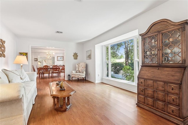 living room with hardwood / wood-style flooring and a chandelier