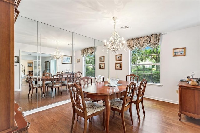 dining area featuring dark hardwood / wood-style floors and a notable chandelier