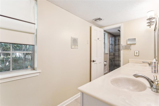 bathroom featuring tile patterned floors, a textured ceiling, and vanity