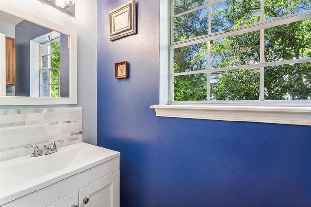 bathroom featuring tasteful backsplash and vanity