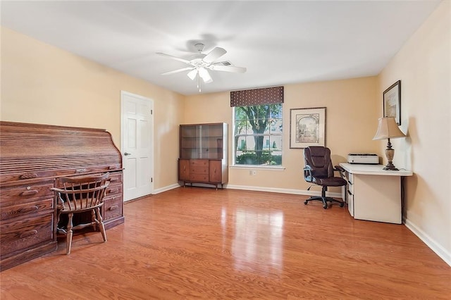 office space with ceiling fan and light hardwood / wood-style flooring