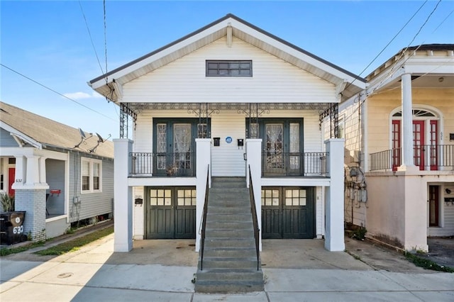 view of front facade featuring covered porch and french doors