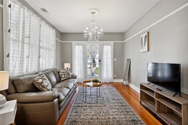 living room with wood-type flooring and a chandelier