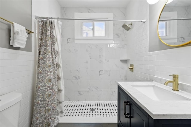 bathroom with tile walls, vanity, and curtained shower