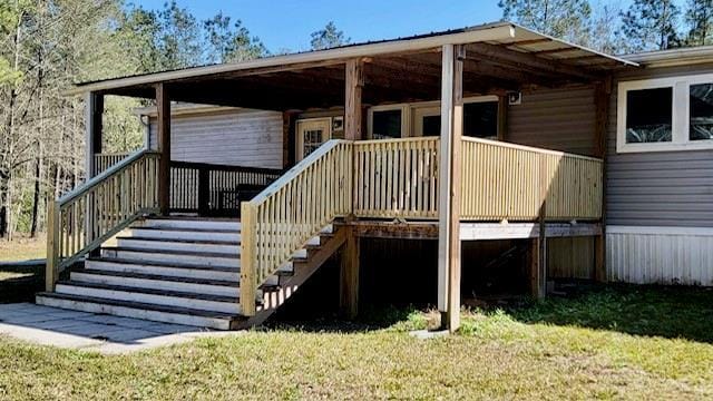 49266 Woodhaven Rd, Tickfaw, LA 70466 - wooden terrace featuring stairs and a lawn